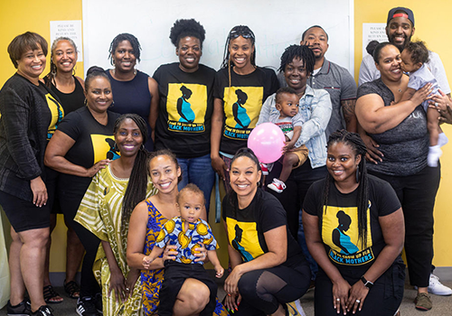 Group of black women at Black Mamas ATX. Some of them are holding babies.